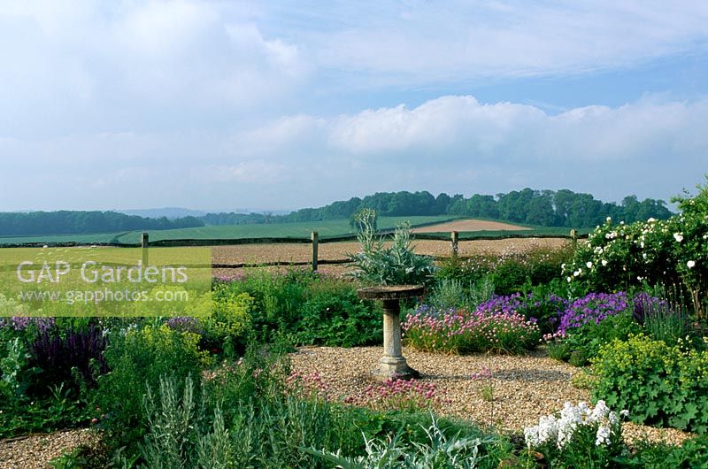 Dry gravel garden with view to surrounding landscape at Frith Hill in Sussex