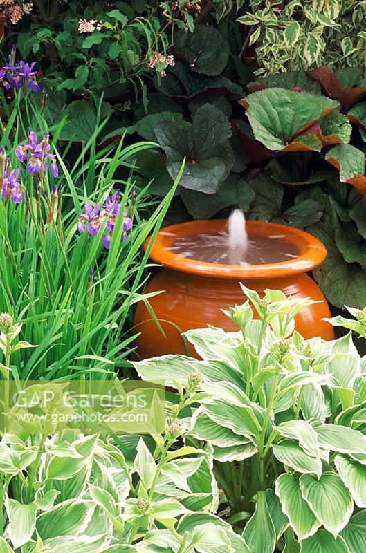 Terracotta urn water feature - water spouting from container
