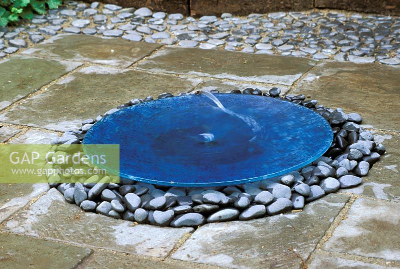 Water feature of large blue bowl on pebbles with water spouting 'As time slips by' Chelsea FS 2003