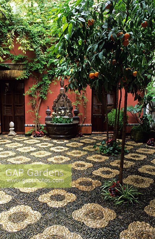 Patio with pebbles mosaics and orange trees in Cordoba patio festival in Spain