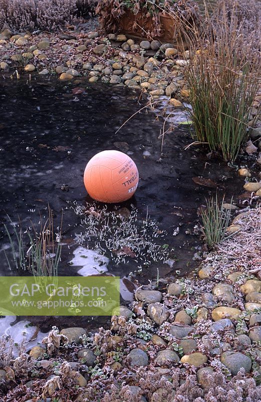 Pond in winter with large ball to prevent ice covering entire surface