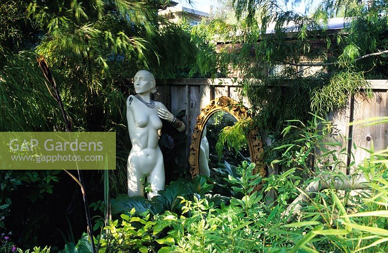 Sharon Osmund's garden. Berkeley. California. Ornaments, sculpture and found objects in small suburban town fantasy garden. 