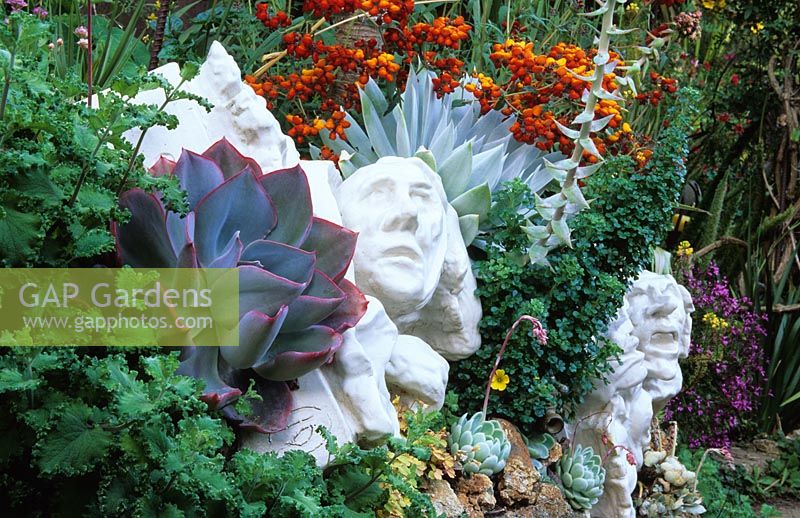 Ceramic sculptures in amongst planting at Roger Raiche's garden in Berkeley, California USA