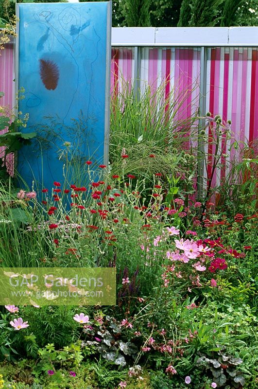 'Looking at the world through rose tinted spectacles' Modern colourful screen amongst planting designed by Wendy Smith and Fern Alder.