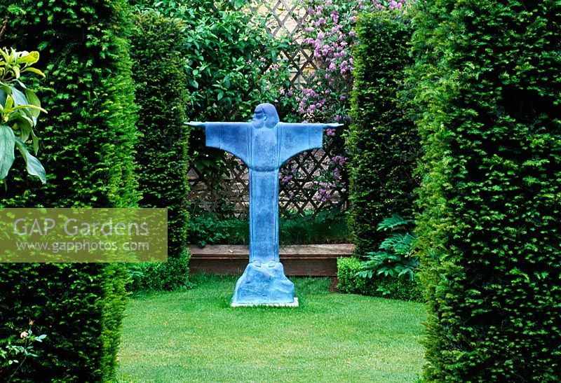 Taxus hedges with view to bronze resin sculpture of St Francis of Assisi by Bill Harling - The Abbey House, Wiltshire 