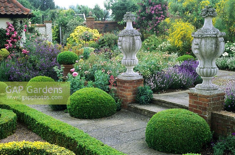Stone ornaments, parterre, patio, Buxus hedges, topiary, Lavandula and Rosa - Kettle Hill, Norfolk 
