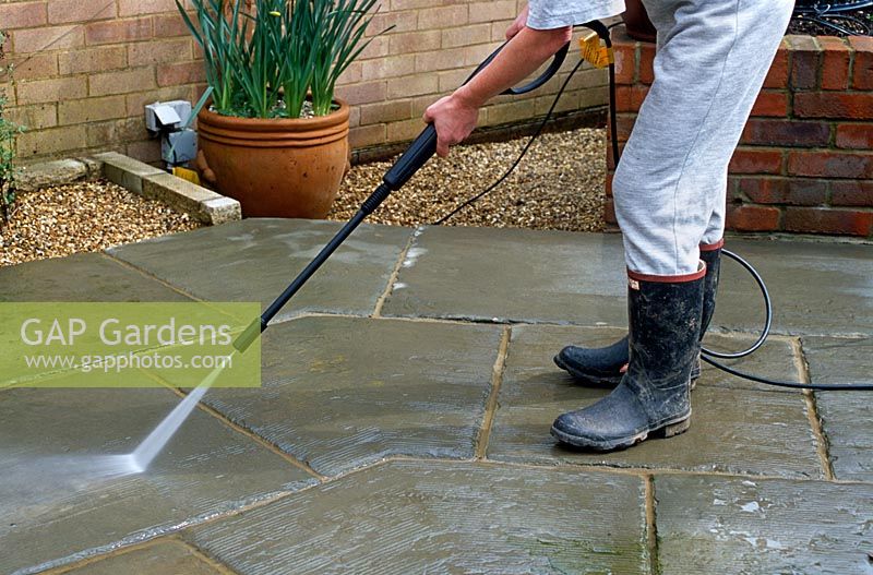Using pressure washer to clean patio slabs