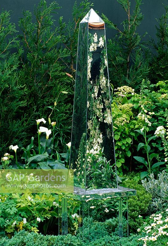 Mirrored obelisk stands in mixed white border with Hostas, Lilium and Digitalis - Homes and Gardens 'The Garden of Reflection' Chelsea 