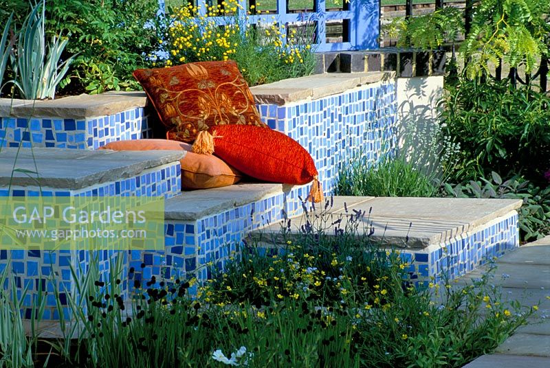 Concrete seats covered with mosaics and red cushions at the Hampton Court 2001
