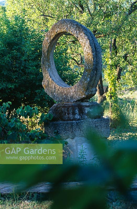 Circular stone sculpture on a stone plinth -La Chabaude, France 