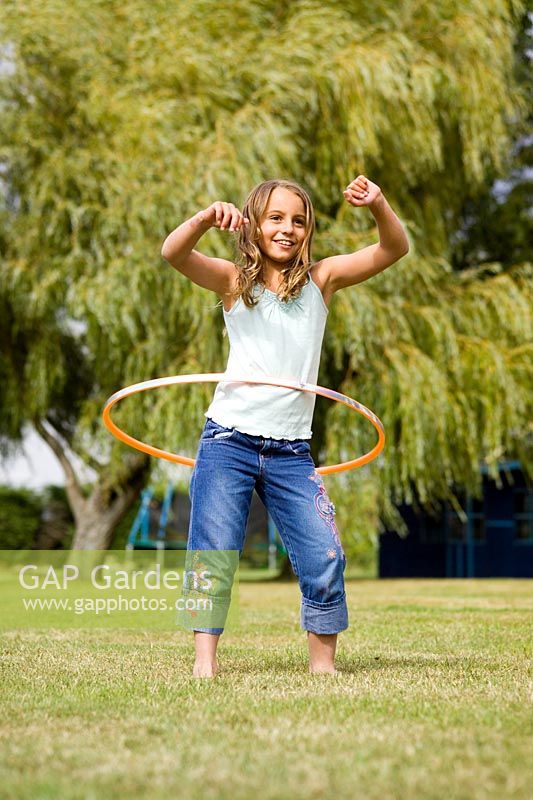 Young girl playing hula hoops
