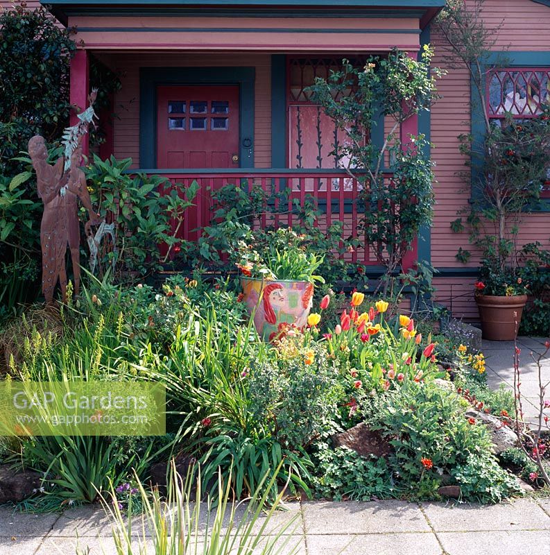 Front garden with sculpture beside women of paradise pot and tulips - San Francisco