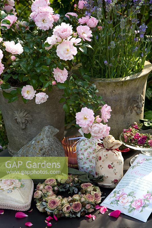 Outdoor still life with roses and homemade lavender bags