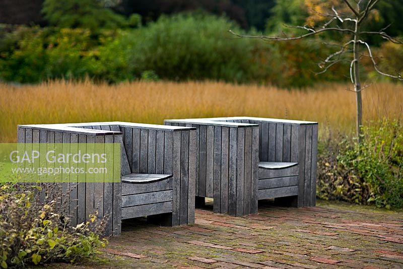 Seating in the 'Drifts of grass' garden at The Walled Garden Scampston, North Yorkshire