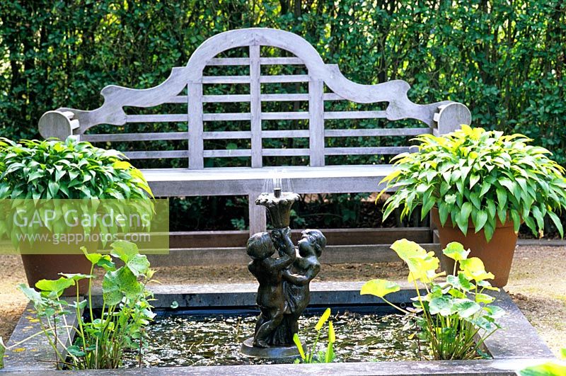 Wooden bench infront of pond