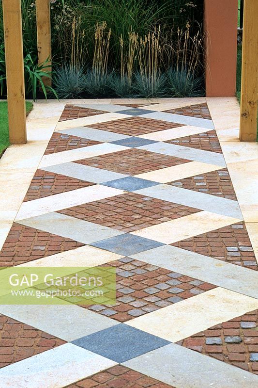 Path with geometric patterns made with brick and stone