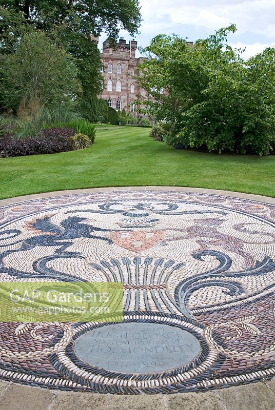 Lawns and gardens to the south of Cholmondeley Castle, Cheshire with memorial pebble mosiac 