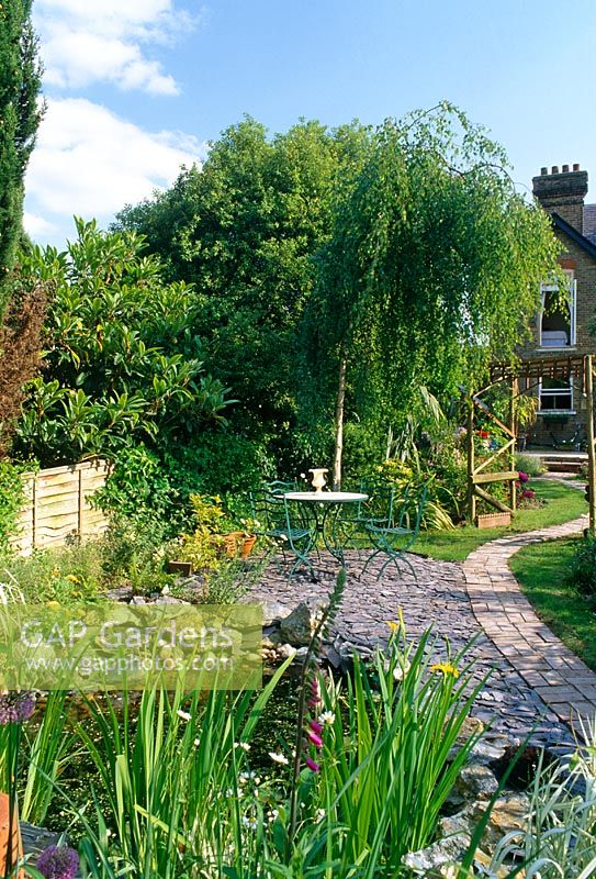 Urban garden with Salix tree, pergola, pond and seating area - Buckhurst Hill Essex