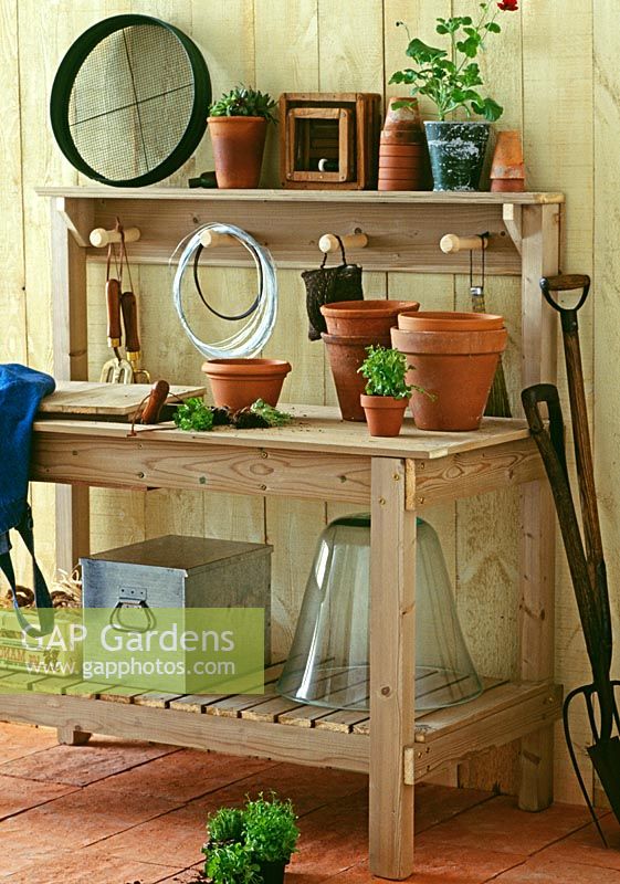 Potting bench with hanging pegs, storage shelf and tray for compost