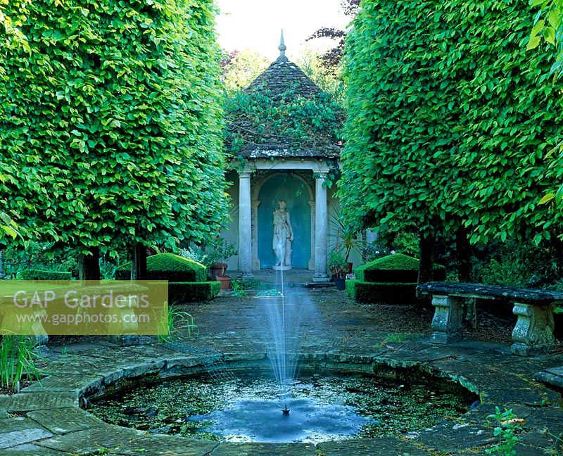 Fountain with view to summerhouse - Watcombe Garden, Somerset