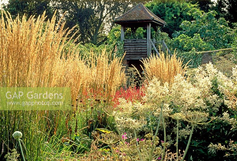 The square garden viewing tower in autumn with Calamagrostis x acutiflora 'Karl Foerster', Persicaria polymorpha and Peucedanum verticillare