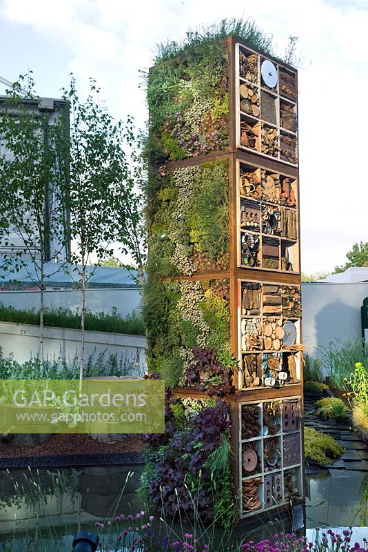 Vertical Garden Tower with mixed planting of edible leaves & herbs, recycled materials for insects to live in. Pond, walls & perennial planting. The Future Nature Garden, Sponsored by Yorkshire Water, University of Sheffield Alumni Fund, Green City Initiative, Buro Happold - RHS Chelsea Flower Show 2009 
