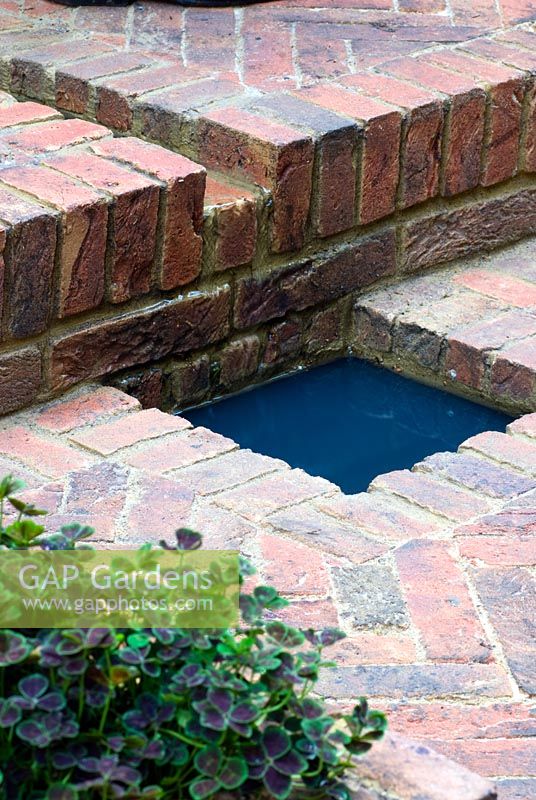 Water rill and pool made from brick. Jacob's Ladder Garden, sponsored by Hewitt Landscapes Ltd - Silver Flora medal winner for Courtyard Garden at RHS Chelsea Flower Show 2009