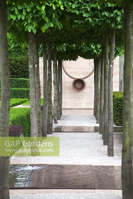 Avenue of Carpinus betulus, Hornbeam with sculpture and water pool - The Laurent-Perrier Garden, Sponsored by Champagne Laurent-Perrier - Gold medal winner at RHS Chelsea Flower Show 2009
