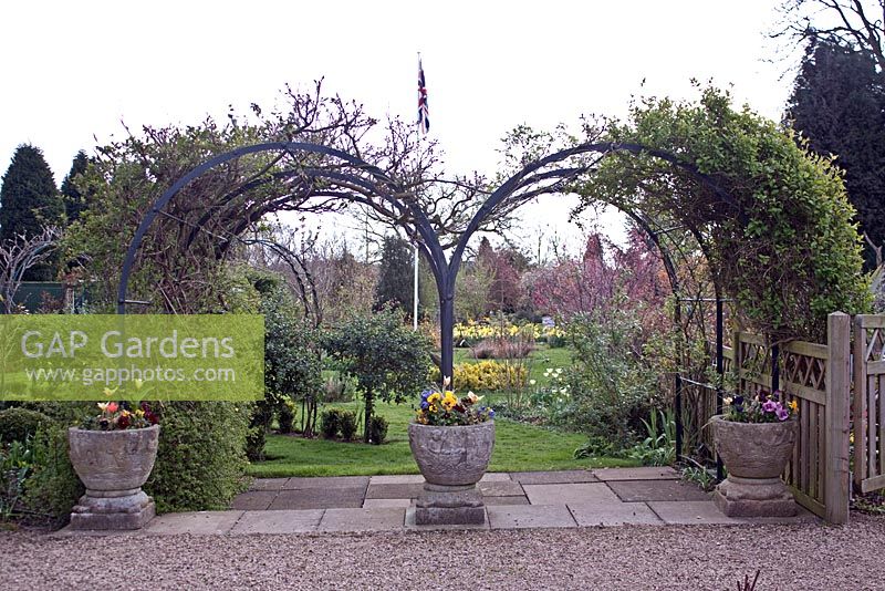 Arches and mixed Spring containers at Coopers Millenium Garden, Lichfield