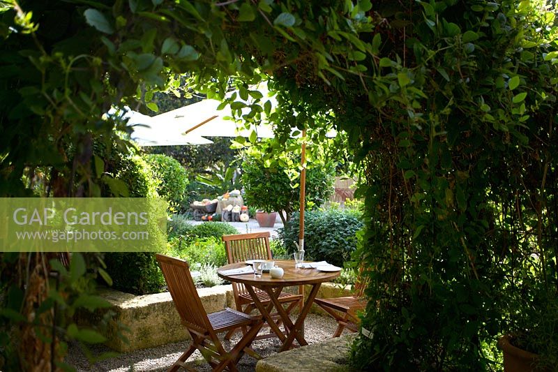 Mediterranean style rustic outdoor dining area in garden setting