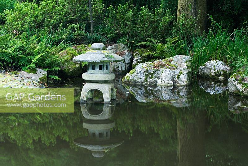 Pine Lodge Gardens - St Austell - Cornwall -The Japanese Garden - Showing a Japanese style lantern on a support in the lake