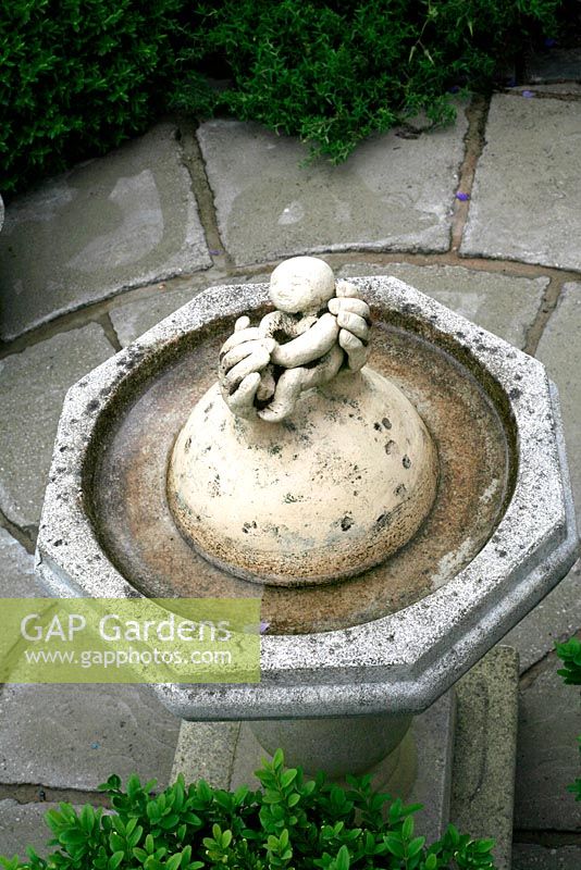 Marijke's garden. Bird bath centrepiece made by Marijke in the form of a mother's hands and child