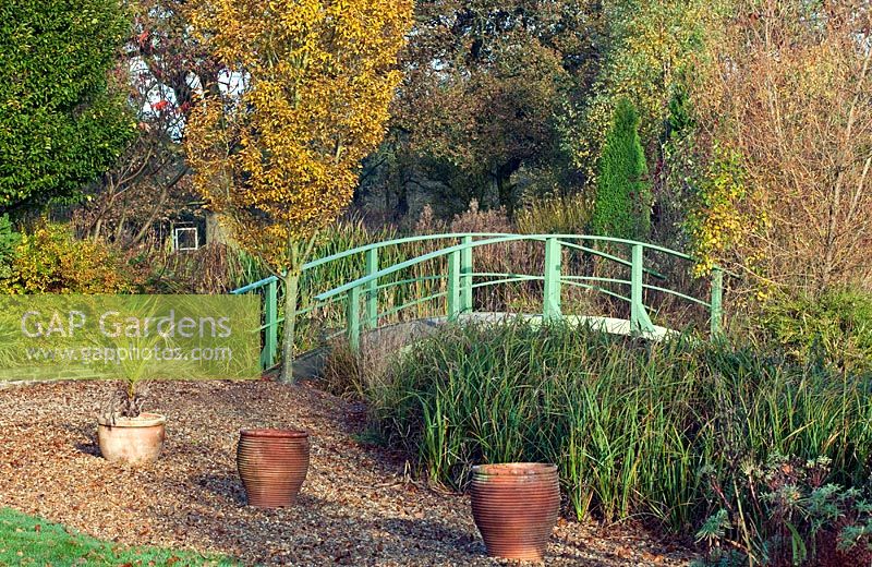 Picturesque aboretum large pond and Monet bridge containers, autumn colour from trees and shrubs at Wilkins Pleck (NGS) Whitmore near Newcastle-under-Lyme in North Staffordshire