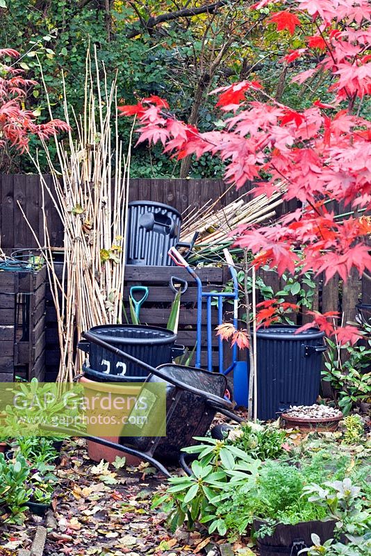 Compost bins and work area Japanese garden in autumn with Acers and many deciduous trees and shrubs grown for their foliage showing stunning Autumnal tints and hues at Four Seasons Garden (NGS) Near Walsall Staffordshire 