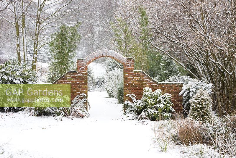 Brick arch and snow in the garden at Honeybrook House Cottage, Worcestershire