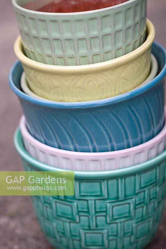 Stack of vintage flower pots in different colors