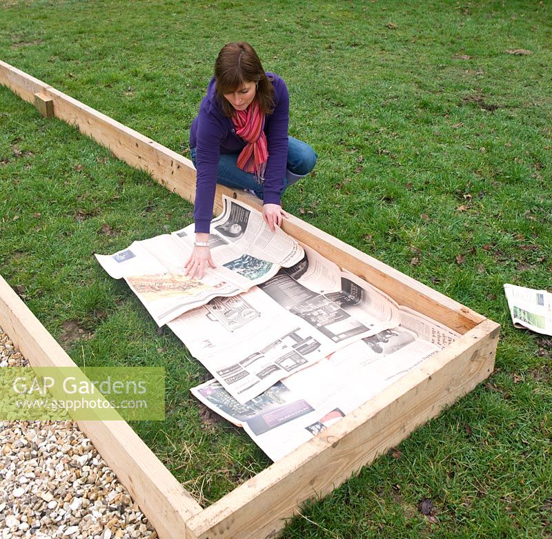 Making a vegetable bed. Clare lays out newspapers for deep mulching. Clare Matthews Vegetable garden project, Devon