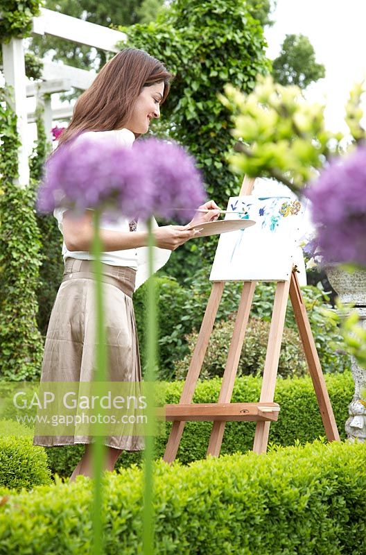 Woman painting in garden