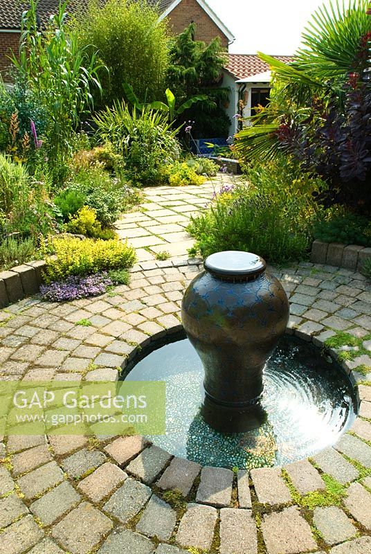 Moroccan Style water feature set in circular paving with mosaic lined pool