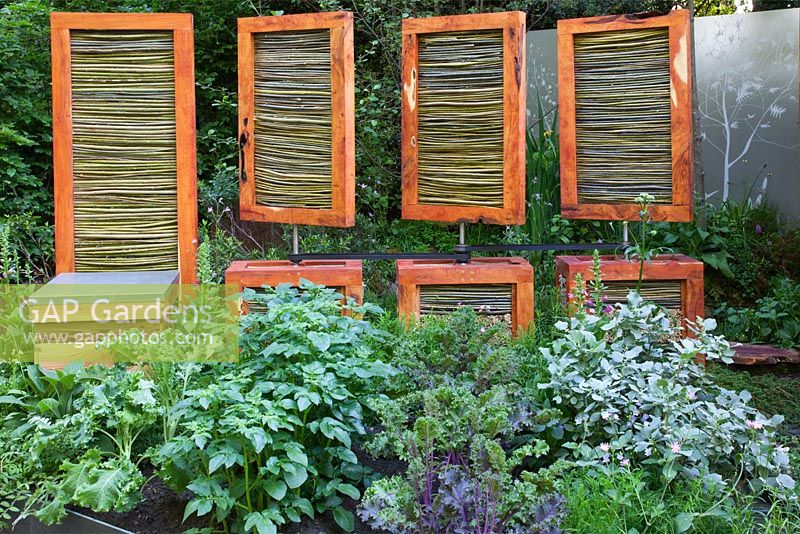 Wind protection screens that can be rotated by power generated by a wind turbine, assembled above insect havens. The SAC Strutt and Parker Sustainable Highland Garden, Silver Medal Winner, RHS Chelsea Flower Show 2010