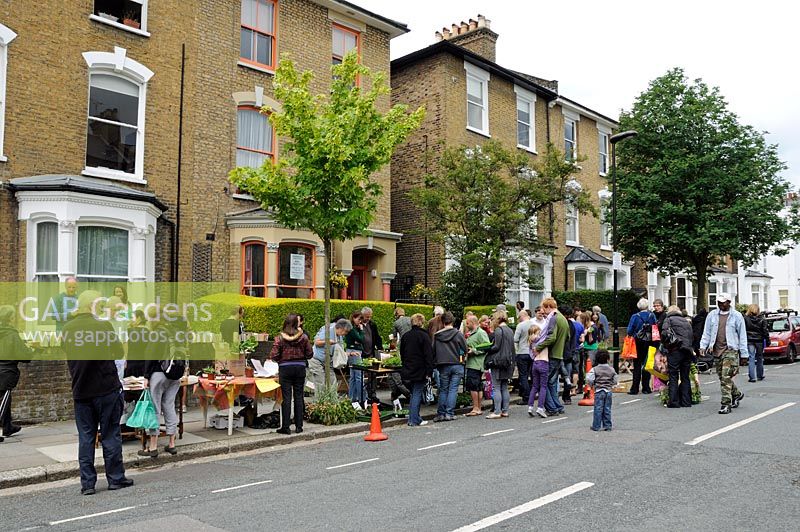 People at plant sale in an urban street, Hackney, London, UK