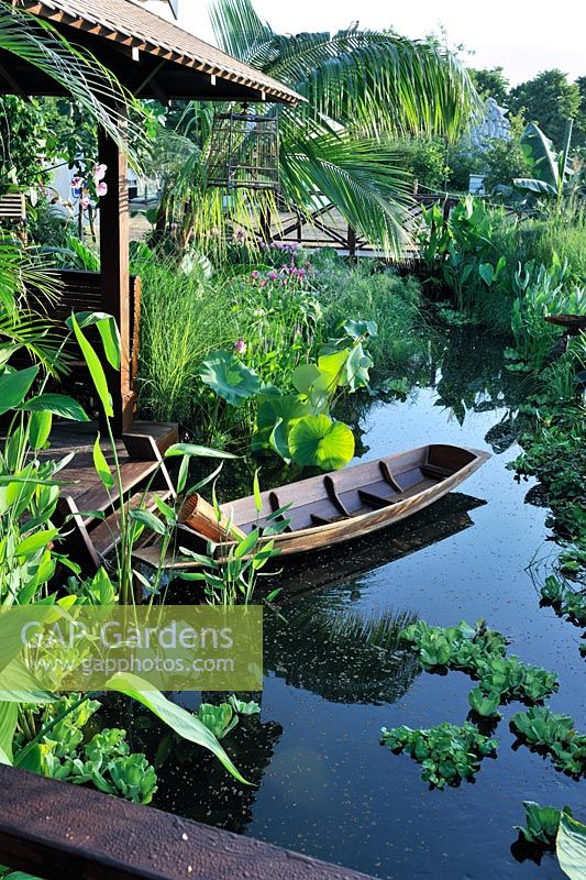 Lush Planting along waters edge in a Bangkok riverside home - Reflections of Thailand - Sala Rim Nam - House by the River, Gold medal winner at RHS Hampton Court Flower Show 2010
