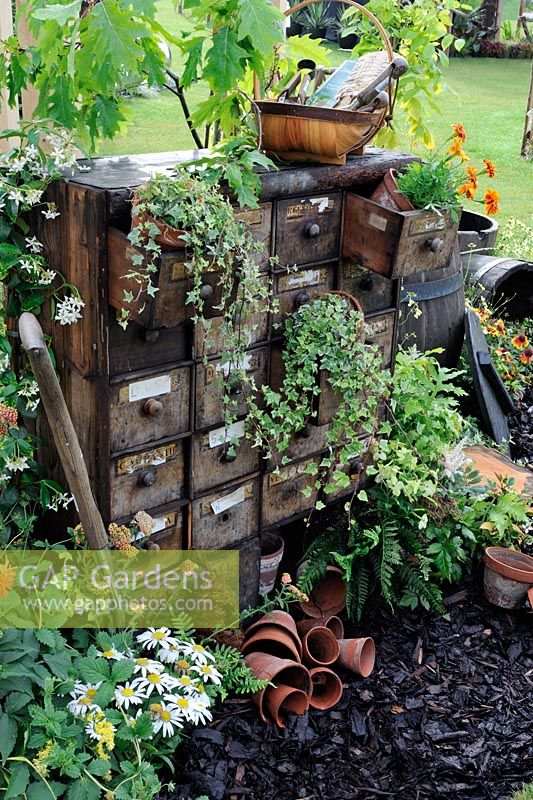 Potting and sowing area with rustic chest of drawers - RHS Tatton park flower Show 2010