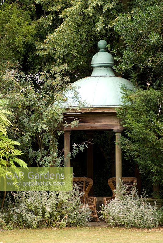 Secluded ornate summerhouse or temple at Docwra's Manor Garden. The garden opens for The National Garden Scheme 