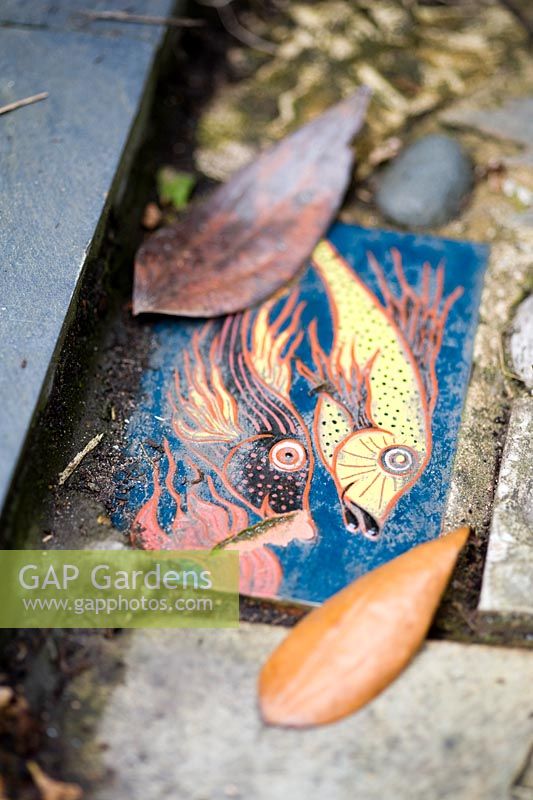 Fish themed tiles set into a path, made by Gordon Cooke