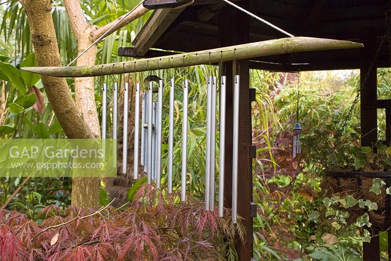 Wind chimes hanging from Pergoda at oriental themed garden - Four Seasons, Staffordshire, NGS
