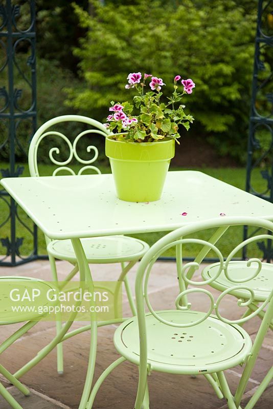 Lime green table and chairs with colour co-ordinated plant pot at Wilkins Pleck, NGS