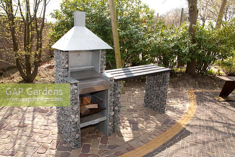 Barbeque made of gabions on patio - Appeltern garden, Holland 