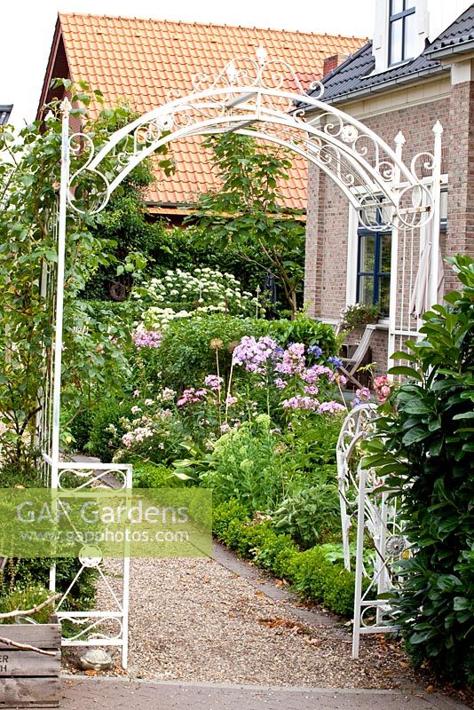 Entrance to garden via arched metal gate