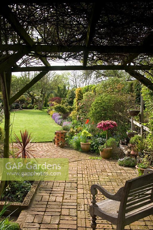 Brick patio with seating area beneath pergola - Rose Cottage Great Brington Northants, NGS